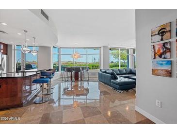 Bright living room boasts an open floorplan, modern furnishings, and expansive windows offering scenic views at 120 E Rio Salado E Pkwy # 102, Tempe, AZ 85281