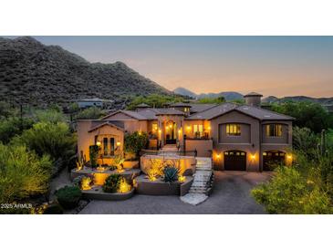 Inviting exterior elevation with meticulously landscaped yard and illuminated by strategically placed outdoor lighting at 14598 E Corrine Dr, Scottsdale, AZ 85259
