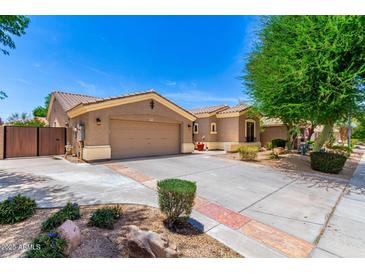Charming single-story home with desert landscaping, a two-car garage, and a private gate at 1865 E Locust Pl, Chandler, AZ 85286
