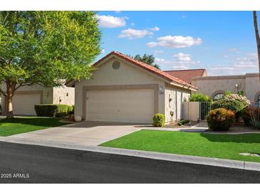 Charming single-story home with a two-car garage, well-maintained lawn, and attractive landscaping at 18780 N 94Th Ave, Peoria, AZ 85382