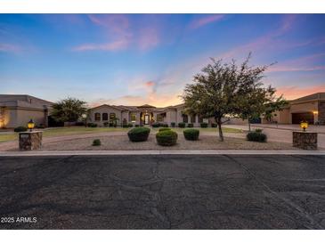 Inviting front exterior showcases lush landscaping and a circular driveway at dusk at 26204 S Washington St, Chandler, AZ 85249