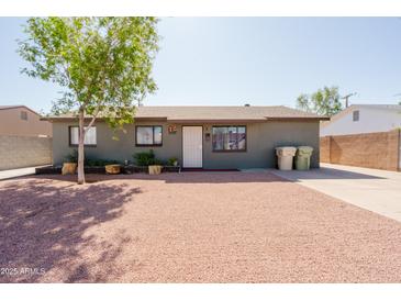 Charming single-story home with gravel front yard and mature landscaping at 5637 N 63Rd Dr, Glendale, AZ 85301