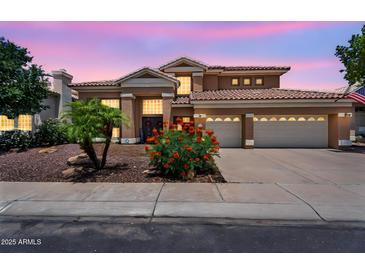 Stunning home with a three-car garage, desert landscaping, and a tile roof in a desirable neighborhood at 6376 W Louise Dr, Glendale, AZ 85310