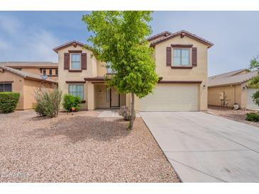 Charming two-story home with a two-car garage and desert landscaping in the front yard at 694 W Desert Seasons Dr, San Tan Valley, AZ 85143