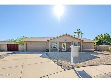 Charming single-story home with a well-maintained front yard and a two-car garage at 12434 S Ki Cir, Phoenix, AZ 85044