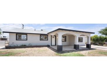 Stylish single-story home with a charming front porch and modern color palette at 1427 W 6Th Dr, Mesa, AZ 85202