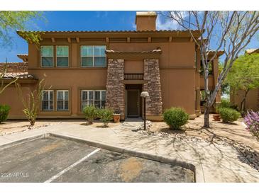 Charming two-story home with stucco exterior and stone accents, situated in a beautifully landscaped yard at 19700 N 76Th St # 1040, Scottsdale, AZ 85255