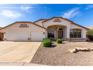 Charming single-story home with a well-manicured gravel yard and a spacious three-car garage at 2230 E Whitten St, Chandler, AZ 85225