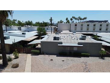 Aerial view of a modern house with desert landscaping, a flat roof, and air conditioning units at 411 W Colter St # A, Phoenix, AZ 85013