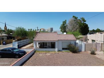 Charming single-Gathering home with red tile roof and low rock landscaping in a residential neighborhood at 42 E 2Nd Ave, Mesa, AZ 85210