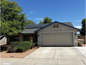 Charming single-story home featuring a two-car garage, solar panels, and well-maintained landscaping at 8540 W Ocotillo Rd, Glendale, AZ 85305