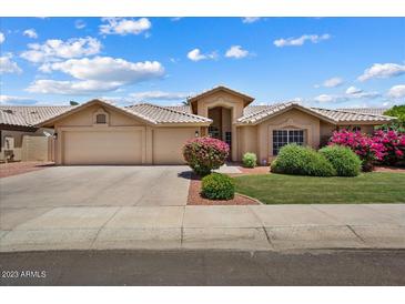 Charming single-story home featuring a well-manicured lawn and attached two-car garage at 14835 N 41St Pl, Phoenix, AZ 85032