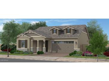 Charming single-story home featuring a two-car garage, covered porch, and beautifully landscaped front yard at 15652 W Pershing St, Surprise, AZ 85379