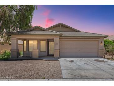 Charming single-story home featuring a well-maintained front yard and a two-car garage at 16783 W Taylor St, Goodyear, AZ 85338