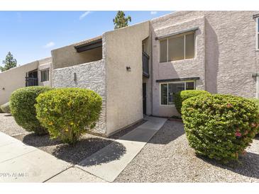 Charming condo featuring well-maintained landscaping and updated exterior paint, in a desirable community at 1927 E Hampton Ave # 204, Mesa, AZ 85204