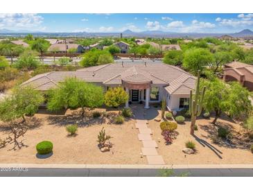 Charming desert home with mature trees, landscaping, a stone walkway, and a prominent portico at 3946 N Pinnacle Hills Cir, Mesa, AZ 85207