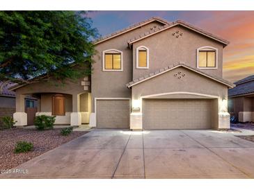 Charming two-story home with a three-car garage and well-maintained landscaping at 46065 W Meadows Ln, Maricopa, AZ 85139