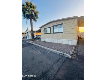 Charming manufactured home featuring a covered parking area and a desert-style landscaped front at 5601 W Missouri Ave # 63, Glendale, AZ 85301