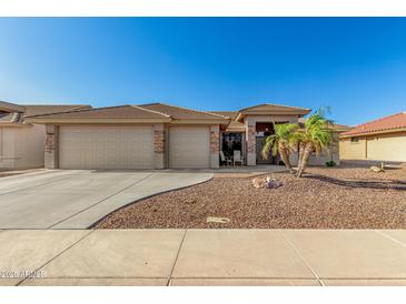 Charming single-story home featuring a well-manicured desert landscape, tile roof, and a spacious two-car garage at 11312 E Newcastle Ave, Mesa, AZ 85209