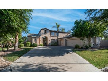 Stunning two-story home with arched entry, mature trees and an attached two-car garage at 1991 W Bartlett Ct, Chandler, AZ 85248