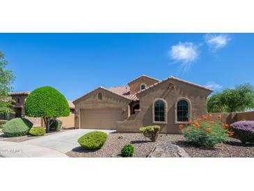 Charming single-story home featuring arched windows, a two-car garage, and well-maintained desert landscaping at 3994 E Grand Canyon Pl, Chandler, AZ 85249