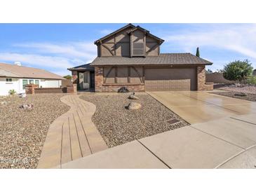 Two-story home boasts a manicured rock yard and a two car garage at 4547 E Buist Ave, Phoenix, AZ 85044