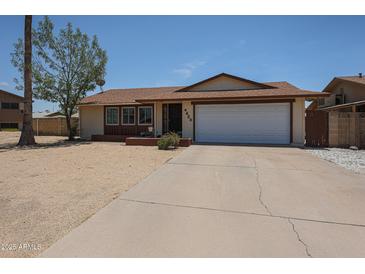 Charming single-story home featuring a two-car garage and low-maintenance desert landscaping in front yard at 4623 W Solano S Dr # South, Glendale, AZ 85301