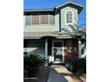 Charming home featuring a covered front door entry, a window, and a well-maintained exterior at 10101 N 91St Ave # 88, Peoria, AZ 85345