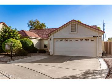 Attractive single-story home featuring a two-car garage, desert landscaping, and a warm, inviting exterior at 1201 E Campbell Ave, Gilbert, AZ 85234