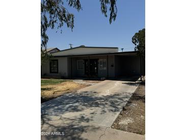 Charming single-story home featuring a covered entry, a carport, and a private driveway at 2045 E Orange St, Tempe, AZ 85281