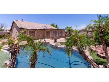 Sparkling pool surrounded by lush landscaping and a screened in porch, perfect for relaxation at 20769 N 106Th Ln, Peoria, AZ 85382