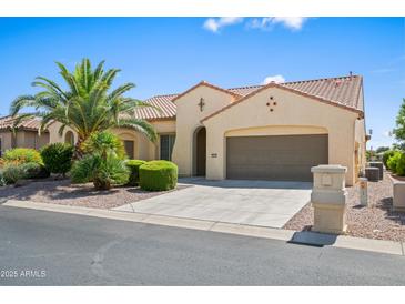 Charming single-story home featuring desert landscaping, a tile roof, and a two-car garage at 2163 N 164Th Dr, Goodyear, AZ 85395