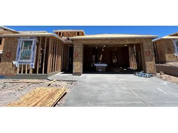 New home construction shows framing stage with garage and WaterBlock wrap at 27358 N 69Th Dr, Peoria, AZ 85383