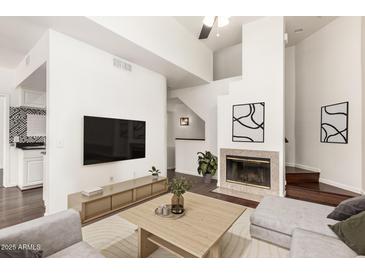 Bright living room with fireplace, flat screen tv, and modern furnishings in neutral color palette at 3633 N 3Rd Ave # 2031, Phoenix, AZ 85013