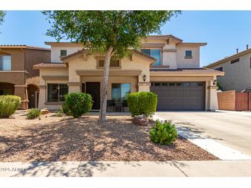 Inviting two-story home featuring a well-maintained front yard with desert landscaping and a spacious two-car garage at 44517 W Copper Trl, Maricopa, AZ 85139