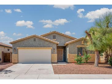 Charming single-story home with a two-car garage, desert landscaping, and a well-maintained lawn at 45391 W Portabello Rd, Maricopa, AZ 85139