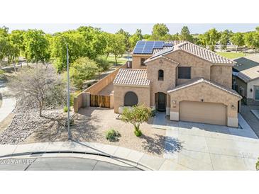 Beautiful two-story home with a neutral exterior, tile roof, desert landscaping, solar panels, and attached garage at 6922 S Black Hills Way, Chandler, AZ 85249