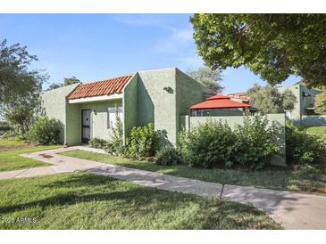 Charming single-story home with landscaped front yard and red tiled roof detail at 735 E Cochise Dr, Phoenix, AZ 85020