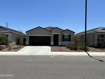 Charming single-story home with a two-car garage and well-maintained front yard at 18765 W Adams St, Buckeye, AZ 85326
