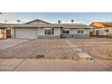 Charming single-story home featuring a spacious front yard with stone landscaping and a two-car garage at 2122 E Radcliffe Dr, Tempe, AZ 85283