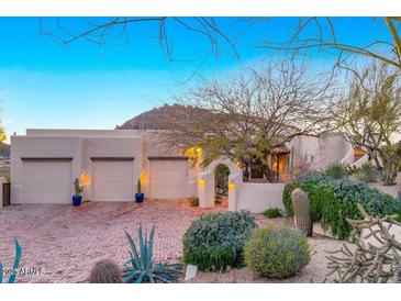 Charming home with desert landscaping, brick driveway, three car garage, and mountain views at 24724 N 119Th Pl, Scottsdale, AZ 85255