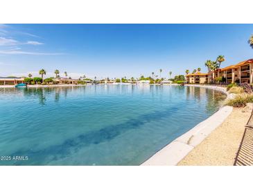 Beautiful view of the large community lake and landscaping on a bright, sunny day at 10330 W Thunderbird Blvd # B112, Sun City, AZ 85351