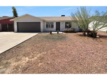 Charming single-story home boasts a well-kept lawn and an inviting facade at 10831 W Heatherbrae Dr, Phoenix, AZ 85037