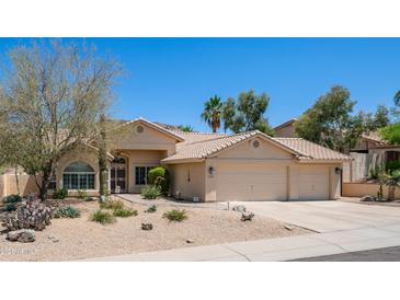 Inviting desert home with a tile roof, xeriscaping, and a neutral color scheme at 116 E Mountain Sky Ave, Phoenix, AZ 85048