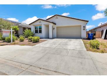 Charming single-Gathering home with desert landscaping and a two-car garage against a blue sky at 12375 W Whyman Ave, Avondale, AZ 85323