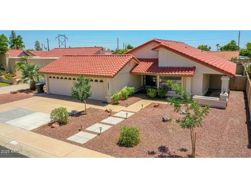 Beautiful single-story home featuring a red tile roof and a well-manicured desert landscape at 12641 S 39Th Pl, Phoenix, AZ 85044