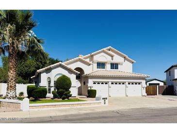 Charming two-story home with a three-car garage, a well-manicured lawn, and mature landscaping at 25015 N 50Th Ave, Phoenix, AZ 85083