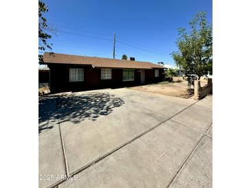 Charming single-story home featuring a large driveway and classic curb appeal at 3211 W Campbell Ave, Phoenix, AZ 85017
