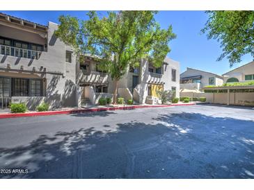 Charming apartment complex with stucco exterior and mature landscaping offering a comfortable living environment at 7300 N Dreamy Draw Dr # 202, Phoenix, AZ 85020