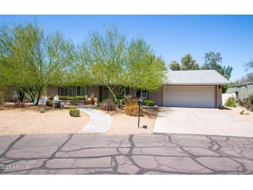 Charming single-story home featuring drought-resistant landscaping and a two car garage at 851 E Village Circle N Dr, Phoenix, AZ 85022